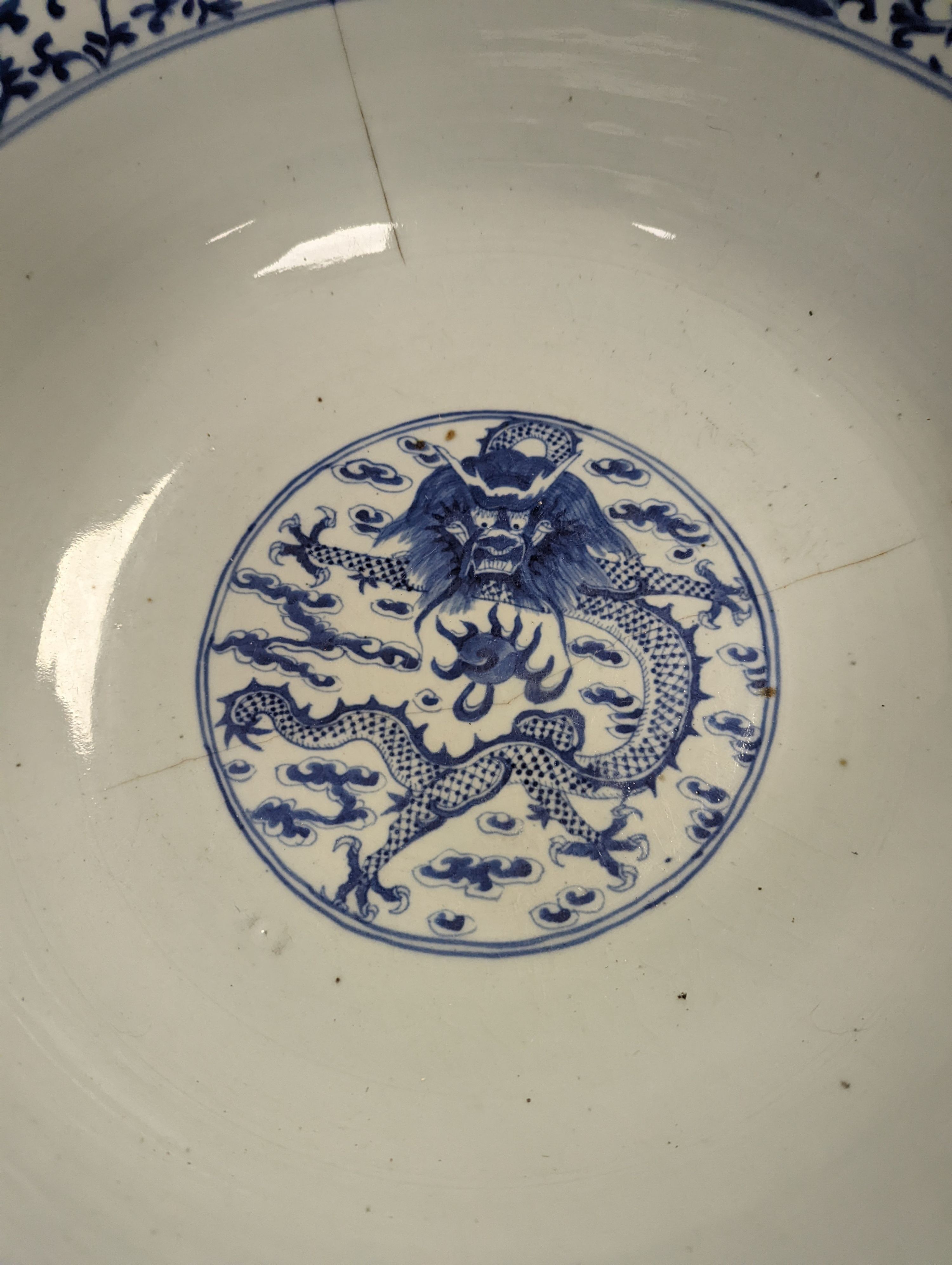 A large 19th century Chinese blue and white ‘dragon’ bowl (a.f.) 41cm